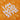 Close-up of "I AM HARDSTYLE" text printed on an orange football shirt with DJ and speaker line art.