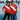 Lifestyle shot of two models wearing the Maradona x COPA Argentinos Juniors 1976 Retro Football Shirt against a graffiti backdrop.