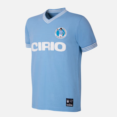 Flat lay of the Maradona x COPA Napoli 1984 Retro Football Shirt, featuring a sky-blue design with Cirio sponsor.