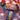 Vintage goalkeeper wearing a multicolored geometric-patterned jersey, raising arms in celebration