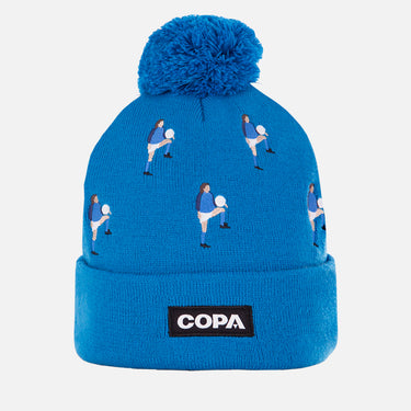 Blue COPA beanie with embroidered football players in vintage kits, pom-pom on top, and COPA logo patch on the cuff