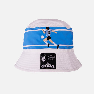 White and blue COPA bucket hat featuring an embroidered Maradona dribbling scene on the side