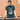 Model wearing the Maradona x COPA Muddy Pitch T-Shirt, standing against a brick wall.