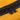 Close-up of yellow fabric and black zipper pulls.