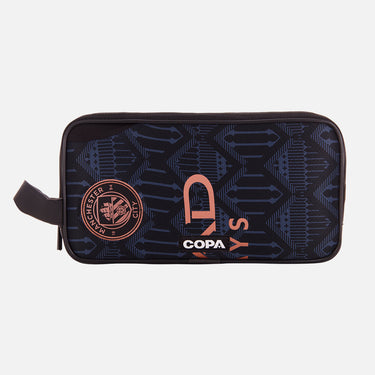 Front view of the recycled toiletry bag featuring a repurposed football shirt with a Manchester City badge and COPA logo