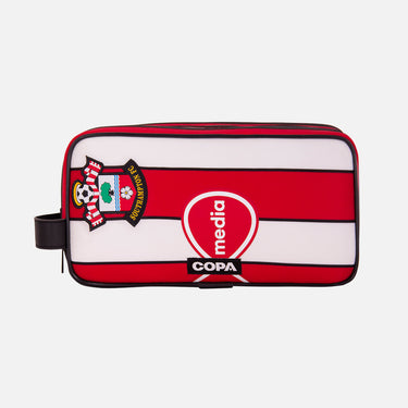 Front view of the recycled toiletry bag featuring a repurposed football shirt with a Southampton badge and COPA logo