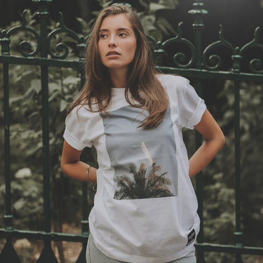 Model wearing the Glory x COPA Floodlights & Palmtrees T-shirt in an outdoor setting.