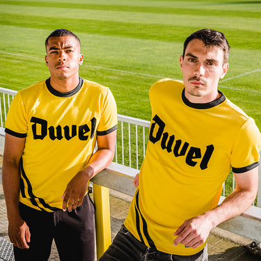 Two models wearing the Berchem Sport 1982 - 83 Retro Football Shirt, standing together outdoors.