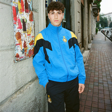 Person wearing FC Internazionale 1997-98 Retro Football Pants, standing outdoors showing full view