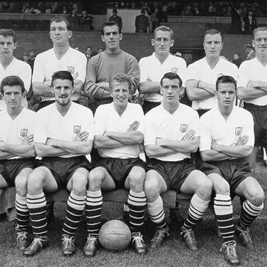Historic black-and-white image of Fulham FC squad from the 1960-61 season, posing with footballs.