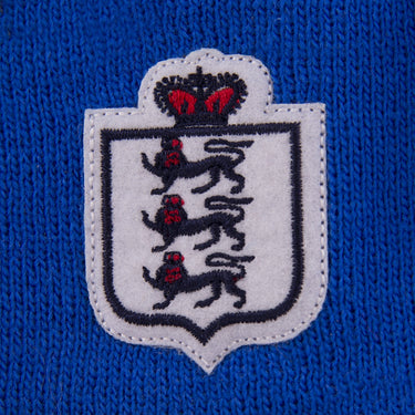 Embroidery detail of the crest featuring three lions and a crown on the blue cuff