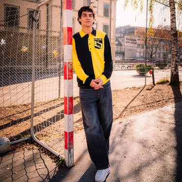 Model wearing the retro Young Boys shirt outdoors, showcasing the bold two-tone design in a casual setting.