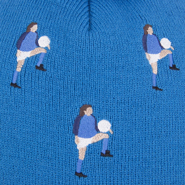 Close-up of the embroidered football players pattern on the blue fabric of the beanie