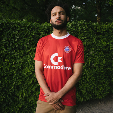 FC Bayern München 1988 - 89 Retro Football Shirt Red & White Lifestyle worn by a model in an outdoor natural setting.