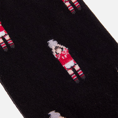 detail of casual black socks with a repeating pixel-style illustration of a footballer holding a trophy above his head refers to denmark 1992