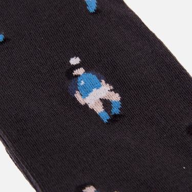detail of casual black socks with a repeating pixel-style illustration of maradona juggling a ball