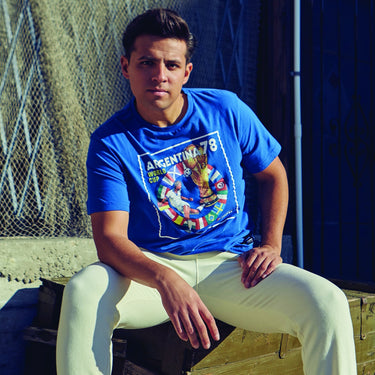 Model wearing the Argentina 78 T-shirt, showcasing the vintage-inspired football design in a casual outdoor setting.
