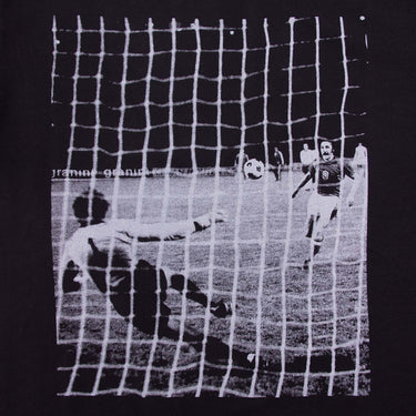 Close-up of the printed design on the Panenka T-Shirt, showing a goalkeeper diving as the ball enters the net.