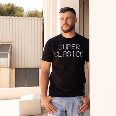 Model wearing the Superclasico T-Shirt in an outdoor casual setting.