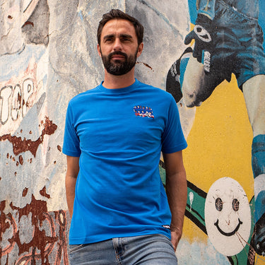 Model wearing the T-shirt in an urban setting, demonstrating its casual and stylish fit.