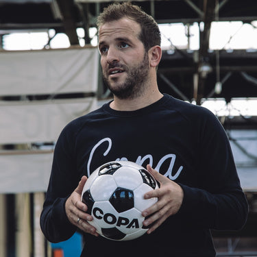 Person holding COPA Match Football Black-White during a training session with the ball in hand