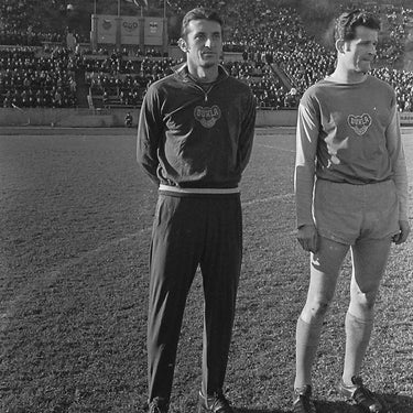 Black and white archive photo of Dukla Prague players standing on the pitch