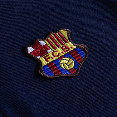 Close-up of retro FC Barcelona crest on 1899 Navy Half Zip Sweater